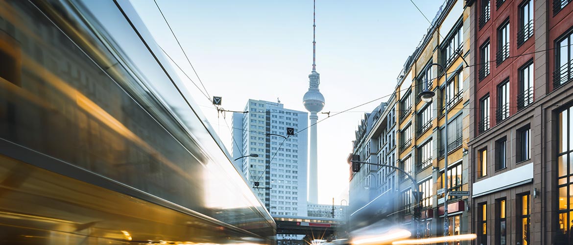 Blick auf den Berliner Fernsehturm mit vorbeifahrenden Straßenbahnen und Hochhäusern – Symbolbild für juristische Fortbildungsveranstaltungen und Präsenzseminare im Deutschen Anwaltsinstitut in Berlin