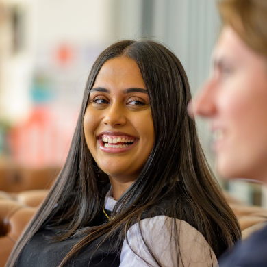 A student smiling at a friend