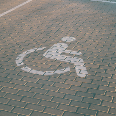 The wheelchair symbol painted in a parking space