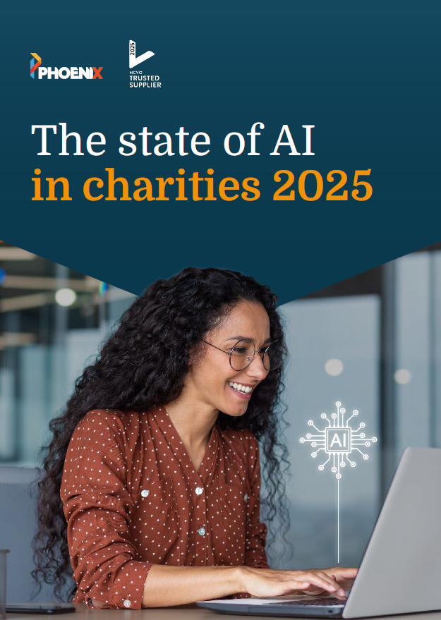 Smiling woman wearing glasses and a brown shirt types on a laptop. The cover text reads: ‘The state of AI in charities 2025.’ Logos for Phoenix and NCVO Trusted Supplier appear at the top, with an AI circuit icon next to the laptop.