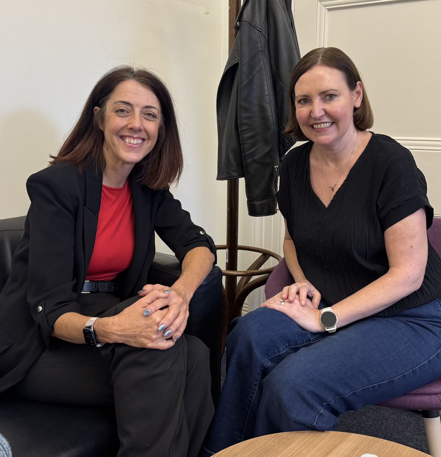 NCVO Chief Executive Kate Lee, on the left, and Minister for Civil Society Vicky Foxcroft MP sit together and smile at the camera.