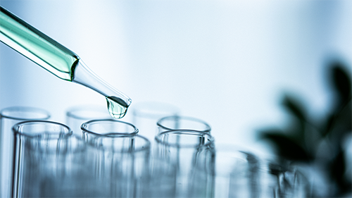 test tubes and light green liquid in a pipette