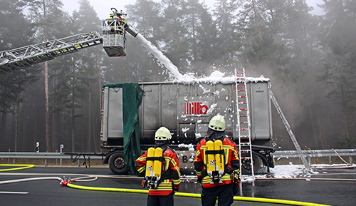 Firefighters spraying firefighting foam