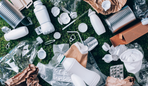 Items made of plastic lying around on green background